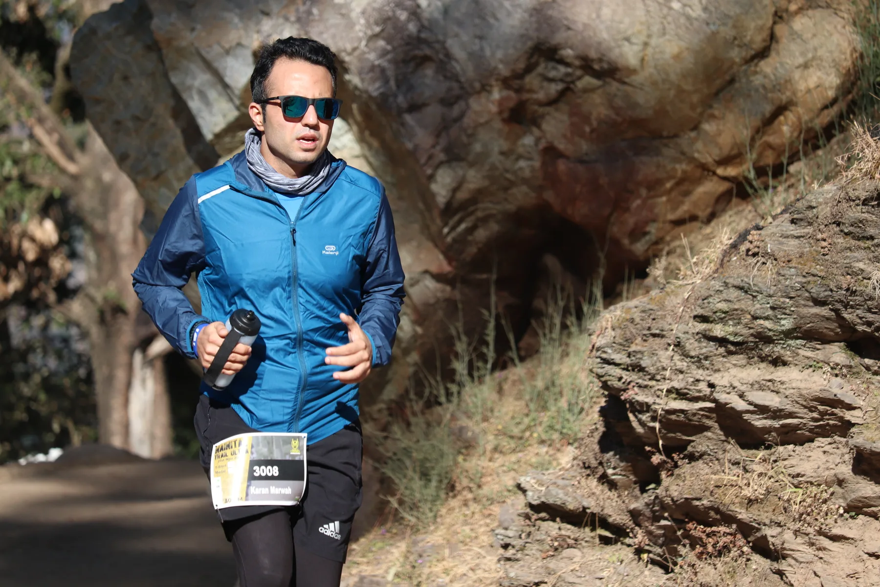 Nainital Trail Ultra archive: Runner passing a rocky section of the course